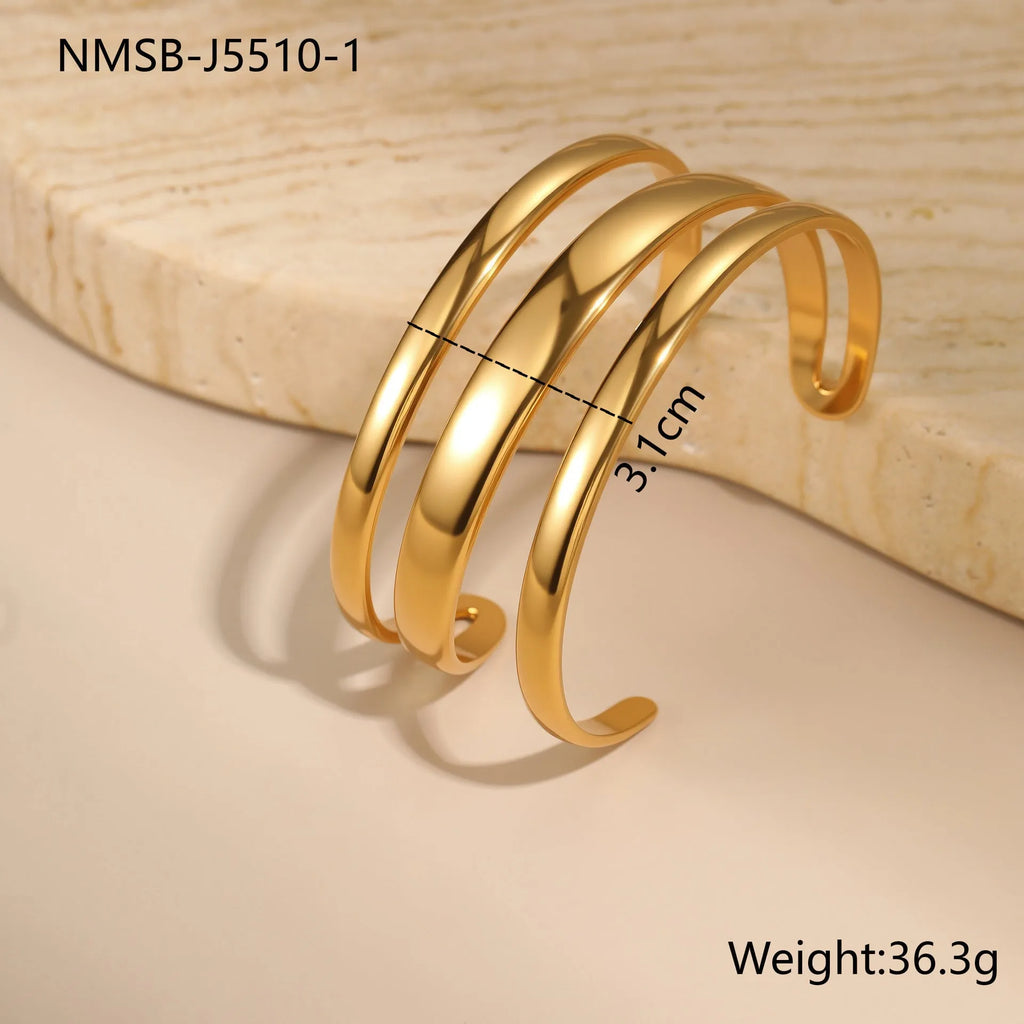 Geometric stainless steel women's bracelet with simple opening, available in gold or steel colour with linear design elements