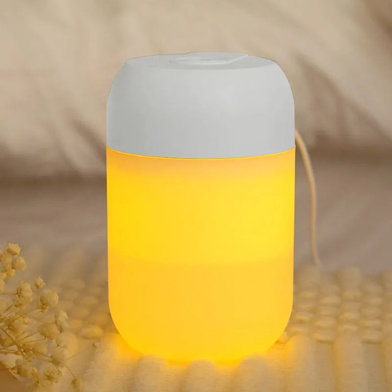 Small white cylindrical USB humidifier with aromatherapy function on a desk.