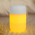 Small white cylindrical USB humidifier with aromatherapy function on a desk.