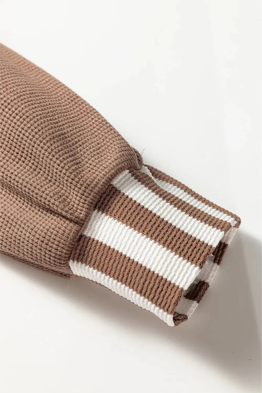 Straw yellow hoodie with waffle texture and striped patchwork design, featuring a button neck and drawstring hood.