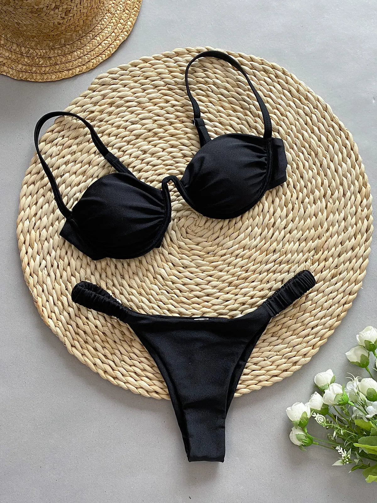Women's black underwire bikini set with briefs style on a mannequin.