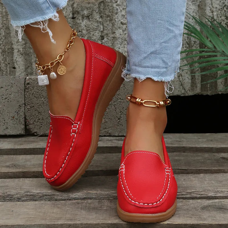 Women's black PU leather flat shoes with round toe and visible car suture stitching detail.