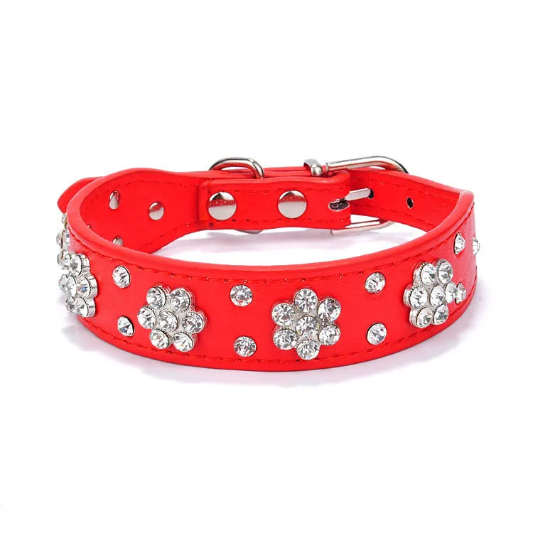 PU leather dog collar with rhinestone flower studs in black, showing metal D-ring and adjustable eyelets.