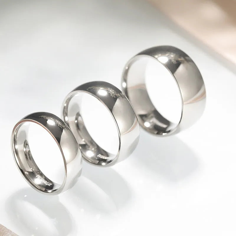Polished silver titanium steel unisex ring shown in 2mm, 4mm, and 6mm width options.