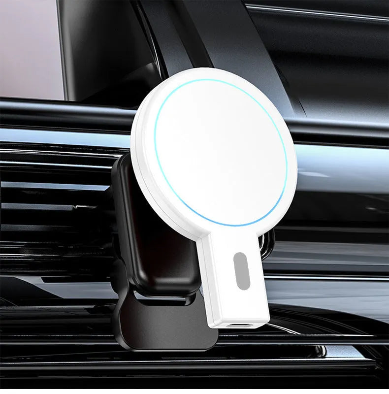 Black and white magnetic wireless charger on a desk with phone