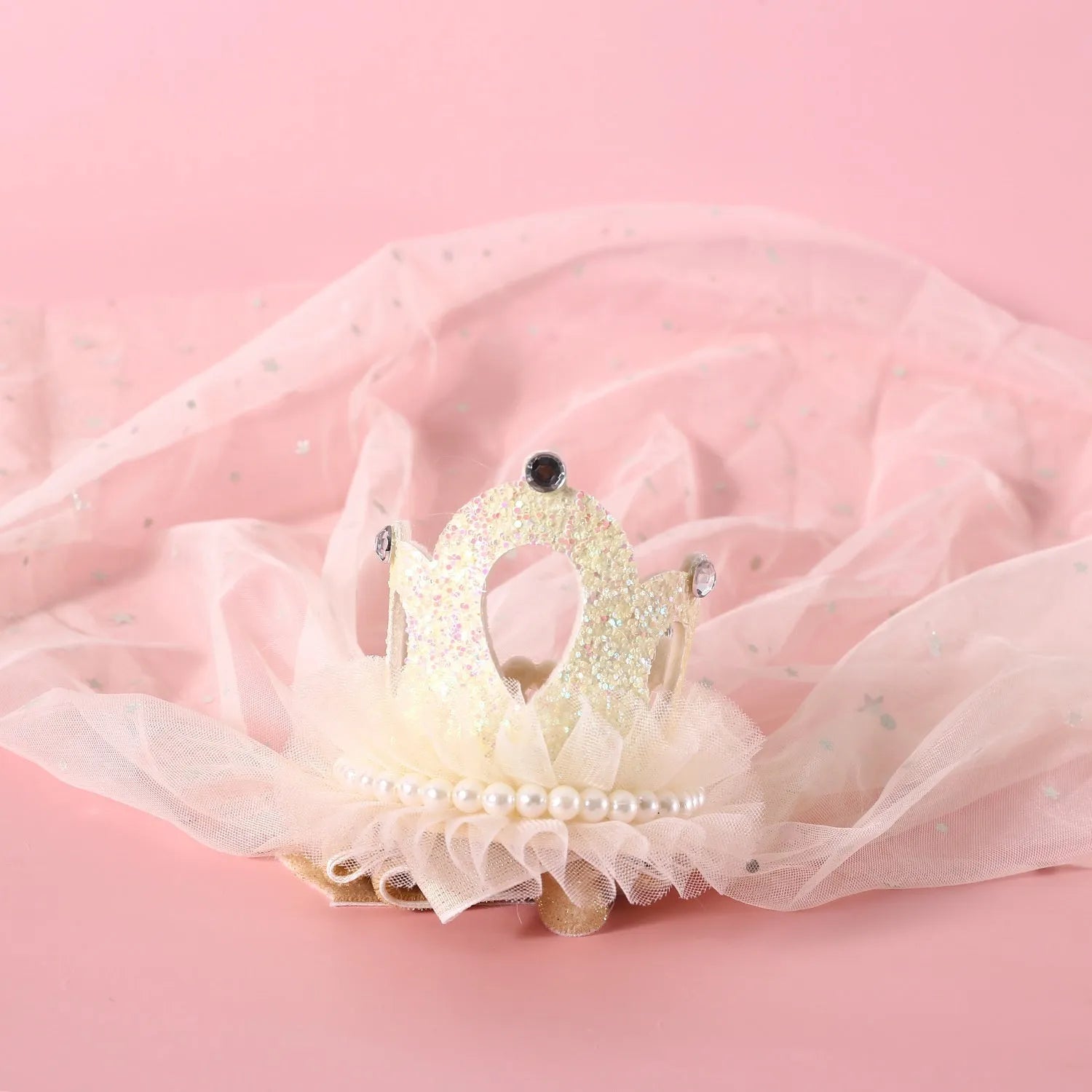 Cat wearing a princess crown headdress with a beige veil, pet wedding accessory