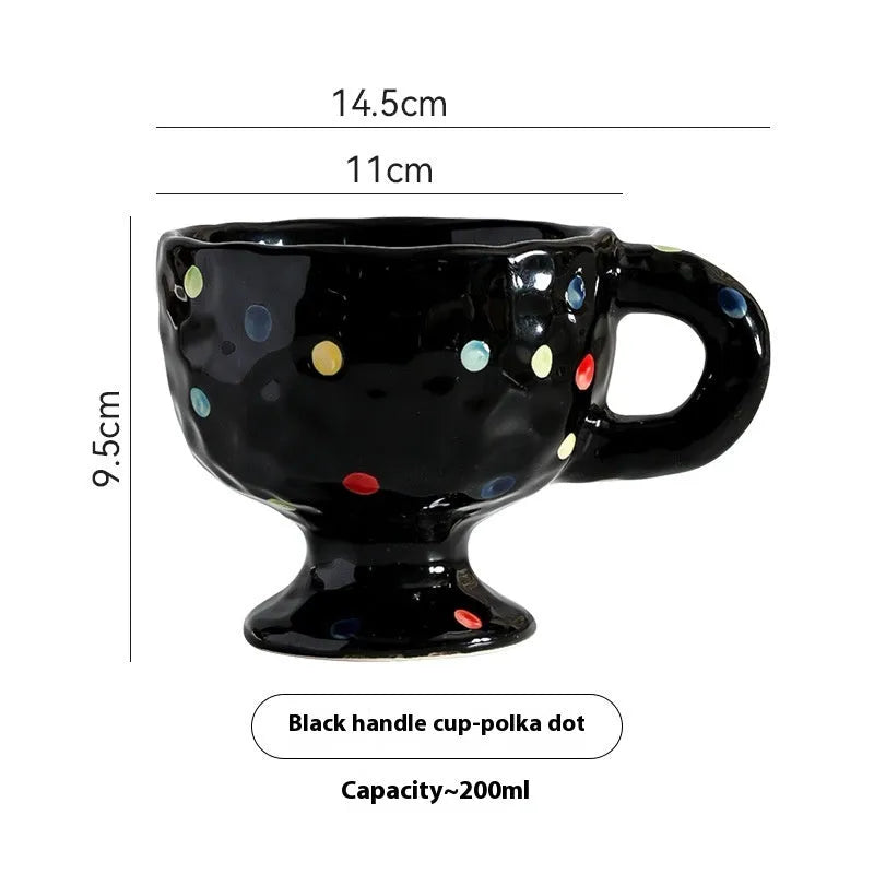 Hand-pinched irregular shaped ceramic mug in a solid colour on a table.