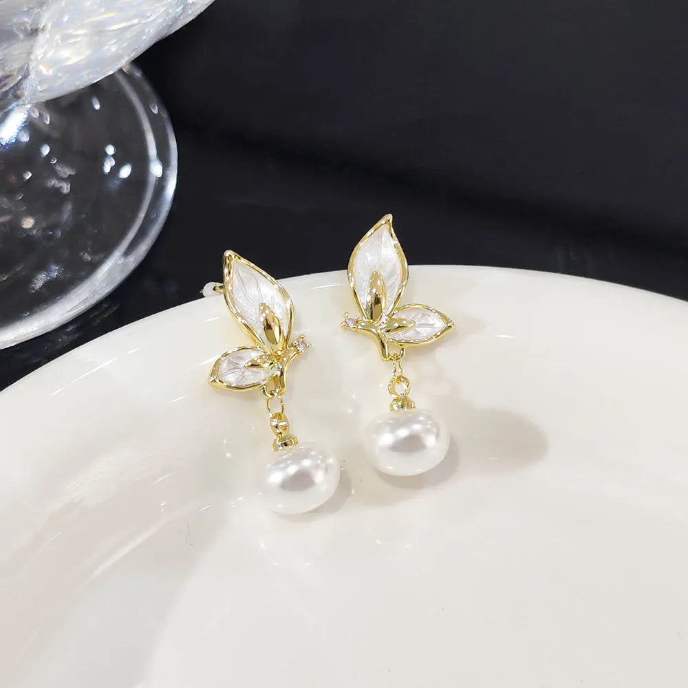 A pair of women's butterfly stud earrings in electroplated copper, colour PT0203, with simple style and painted zircon detail.