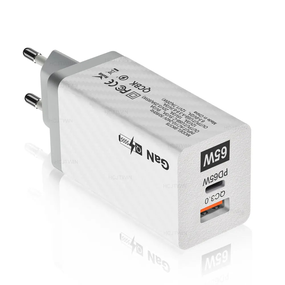 White gallium nitride GaN 65W laptop charger with USB-C port shown next to EU, UK, and US plug options