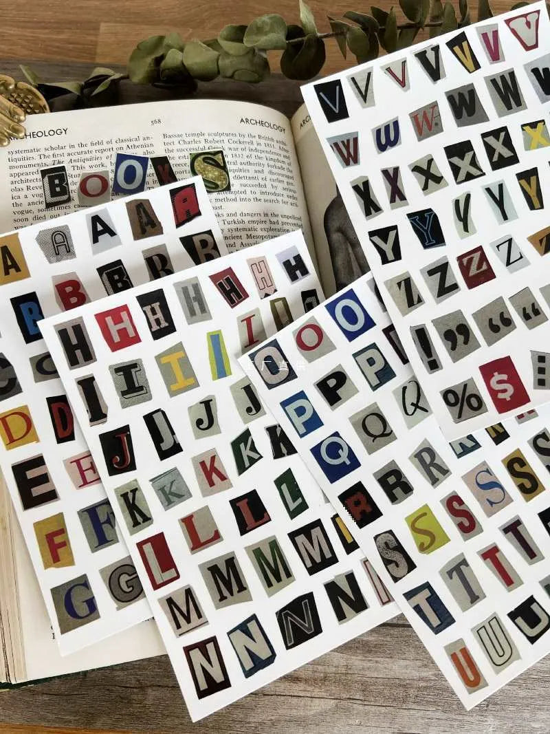 Set of printed cute style decoration stickers showing English letters, numbers, and weekly words on sheets.