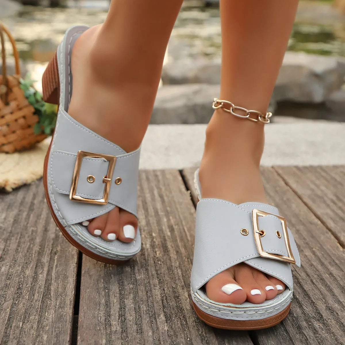 Women's retro chunky heel slippers with a metal buckle in black and light blue colours.