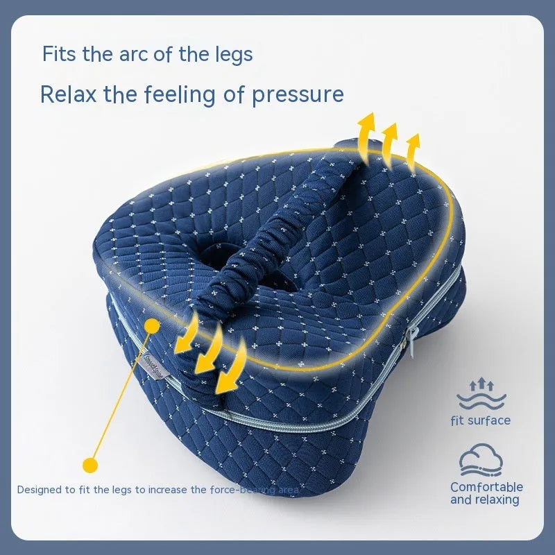 Heart-shaped dark blue memory foam leg pillow for adult knee or ankle support.