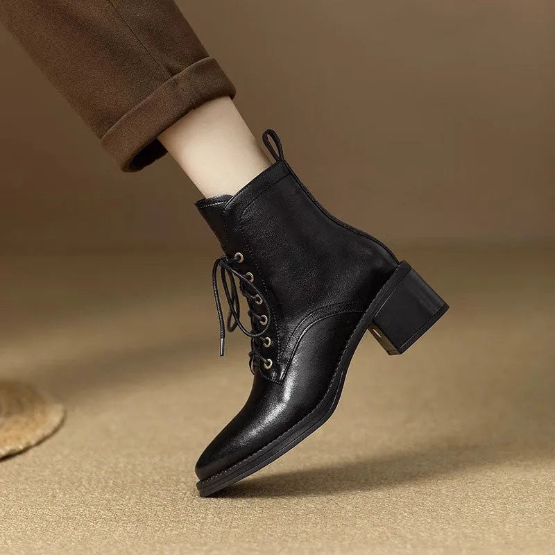 Women's black pointed toe short tube ankle boots with 5.5cm heel on wooden floor