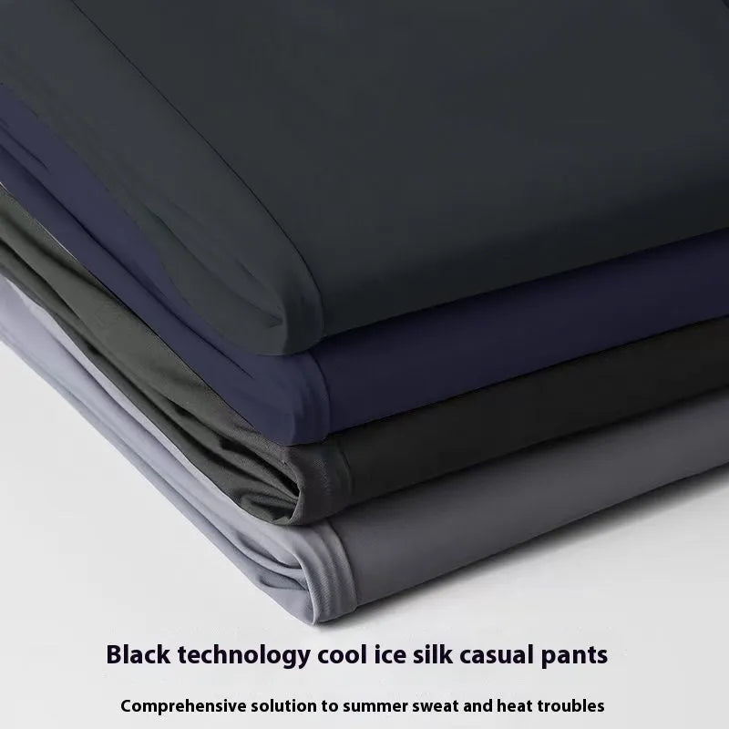 Men's black ice silk leisure trousers with elastic waist and straight leg design laid flat