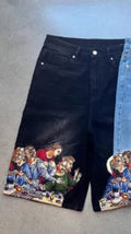 Blue cotton men's shorts with a Jesus Christ screen print on the back pocket, showing tapered leg fit.
