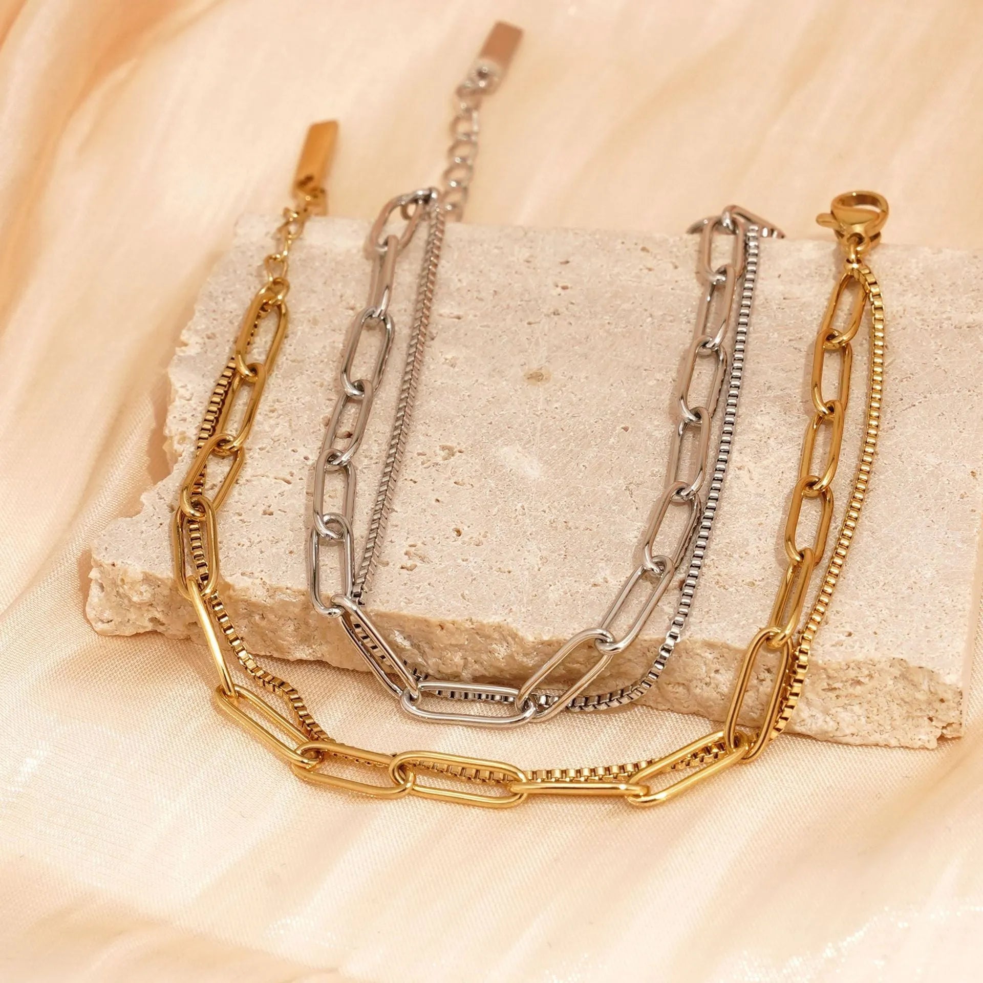 Gold and silver geometric double-layer stainless steel women's bracelet with linear design.