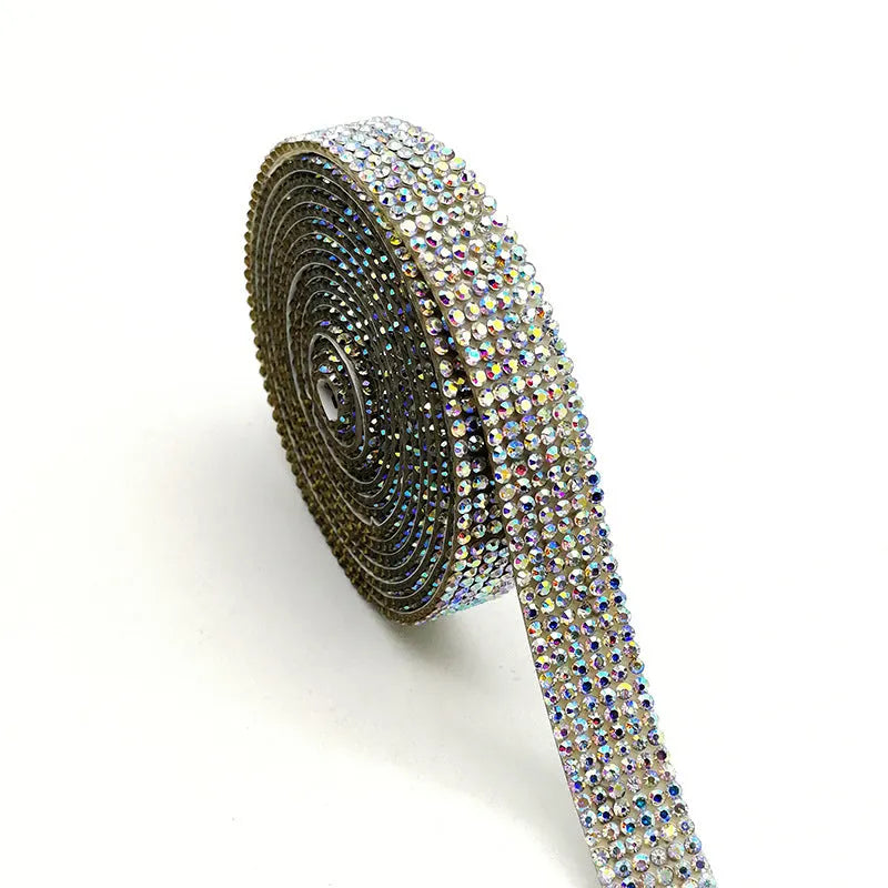A one-yard long self-adhesive electroplated glass rhinestone strip on a roll, shown in white and AB colour variants.
