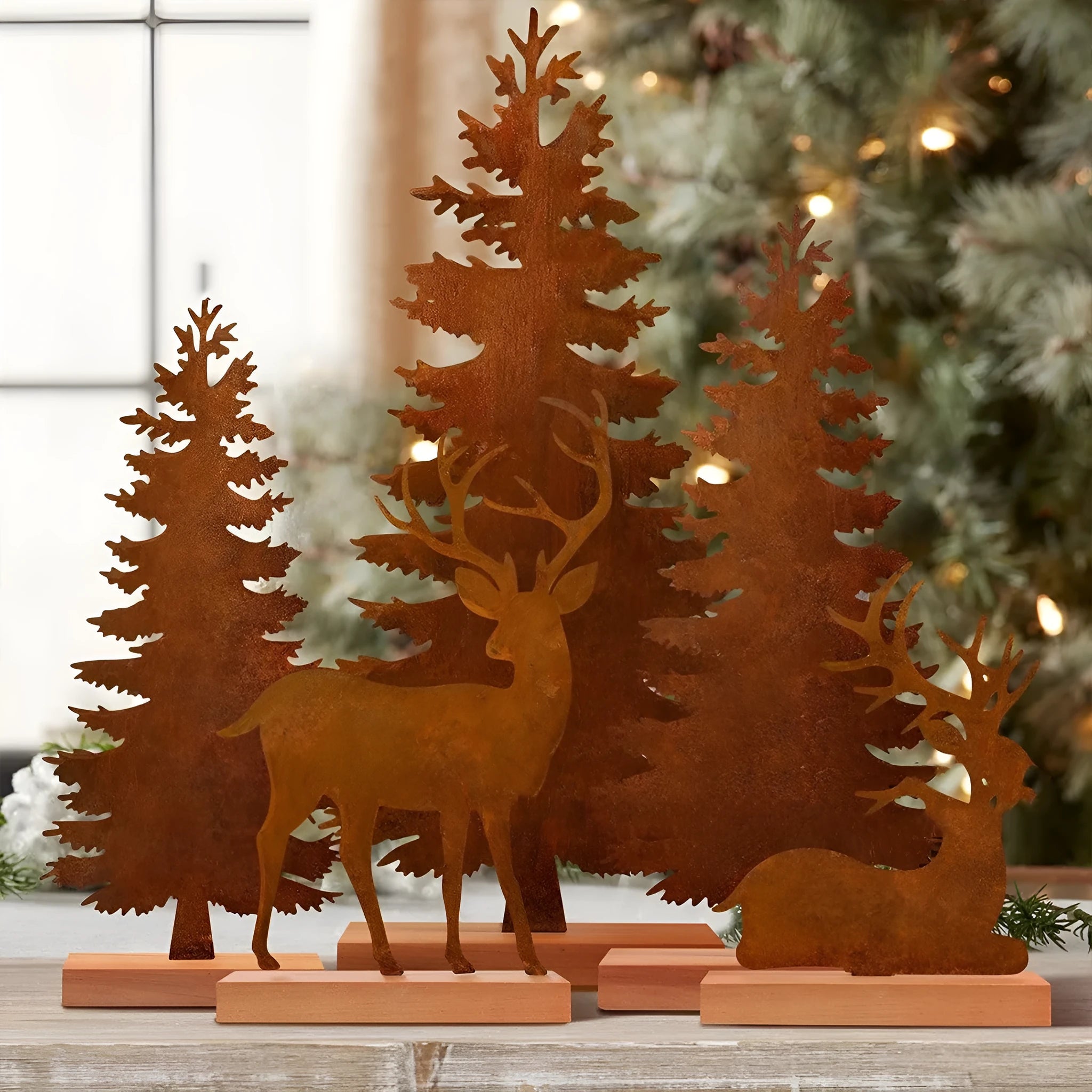 Set of three rusty metal Christmas ornaments featuring elk and tree designs.