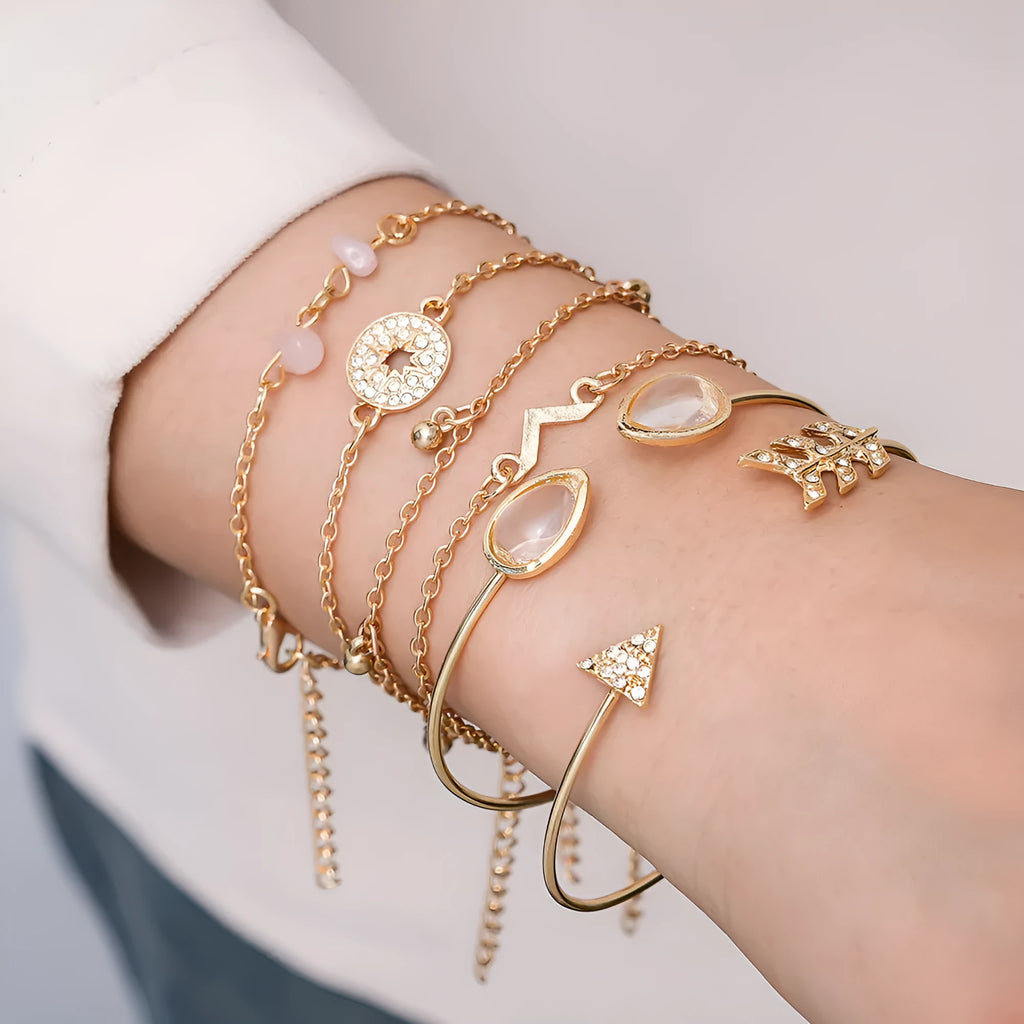 Gold-coloured women's bracelet set with six pieces showing spot drill arrow and water drop V-shaped charms