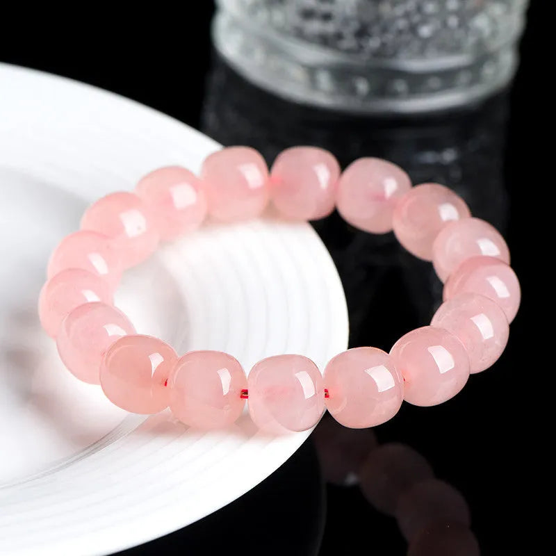 Pink natural crystal barrel bead bracelet with 8x10mm geometric design and polished finish
