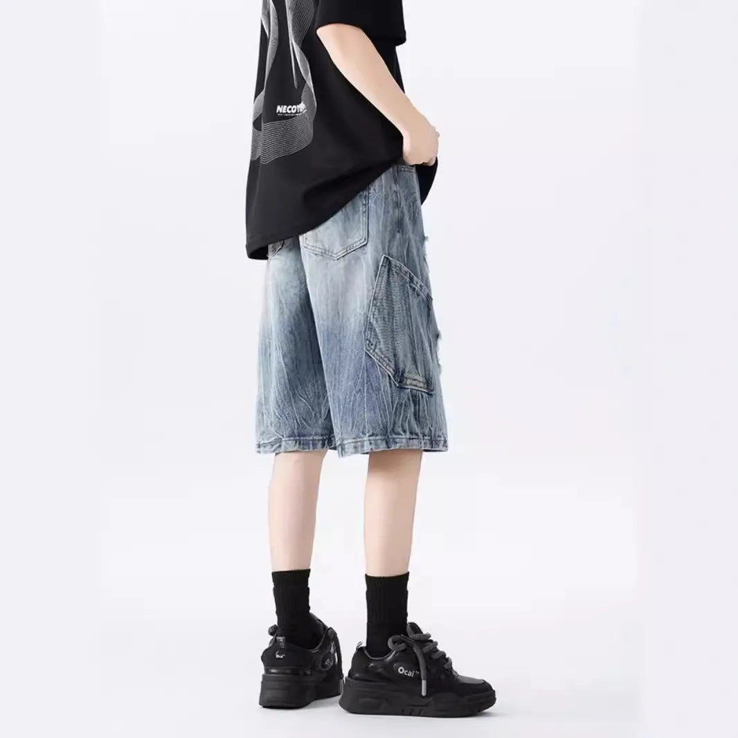 Washed denim shorts with ripped detailing in loose retro style, available in black or blue