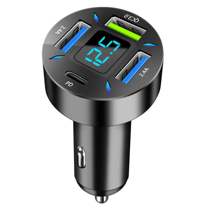 Black four-port USB car charger with digital LED display, shown plugged into a car dashboard.