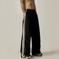 Black high-waisted wide-leg polyester climbing trousers for men laid flat.