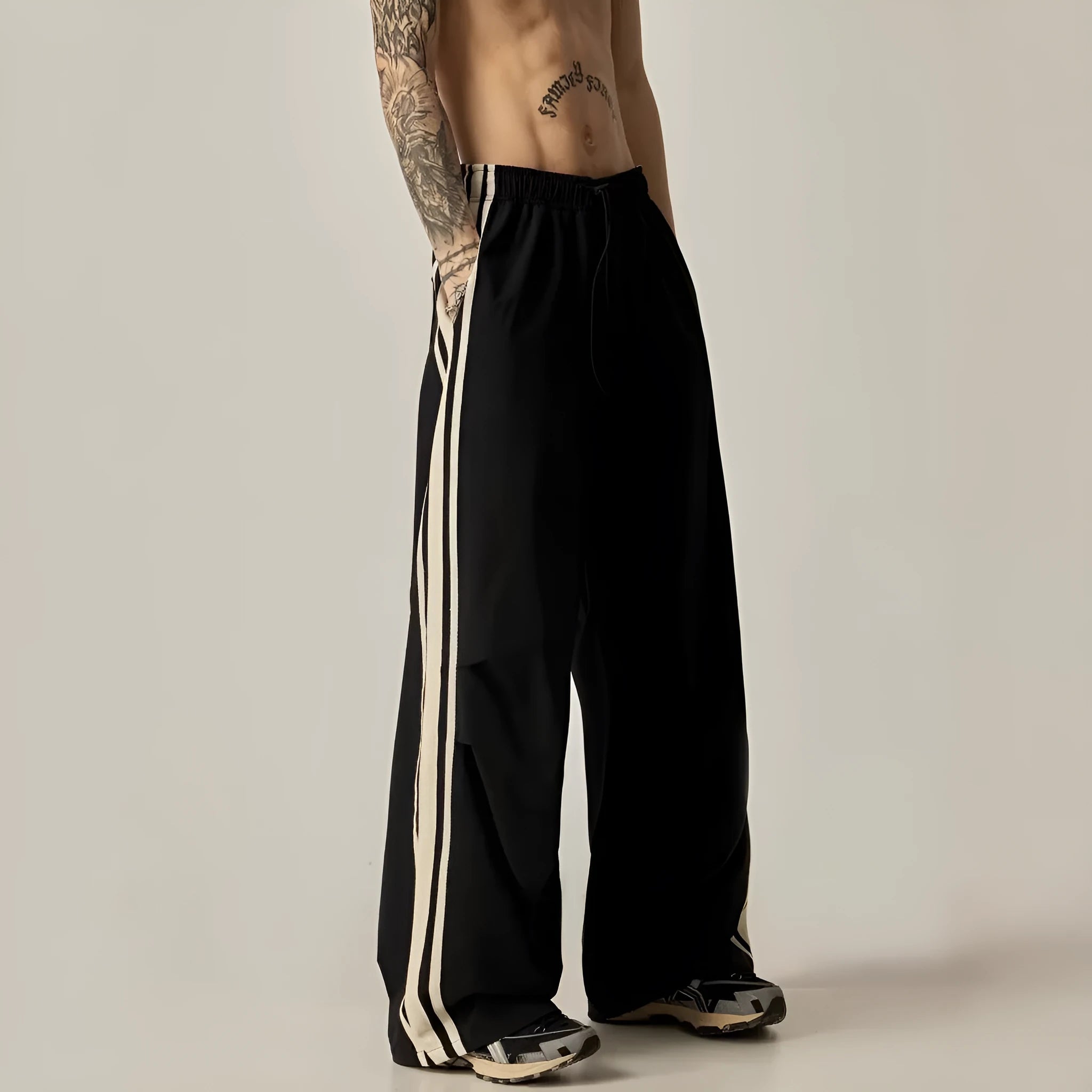 Black high-waisted wide-leg polyester climbing trousers for men laid flat.