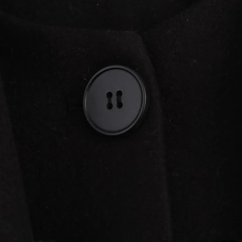 Women's long black polyester coat with a fluffy artificial fur collar, side pockets, and a street-fashion silhouette.