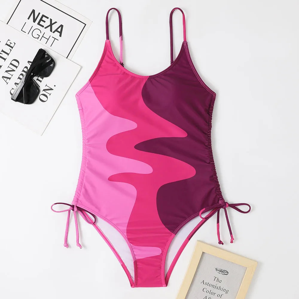 Blue women's sleeveless backless one-piece swimsuit with a striped print, made from polyester and nylon fabric.