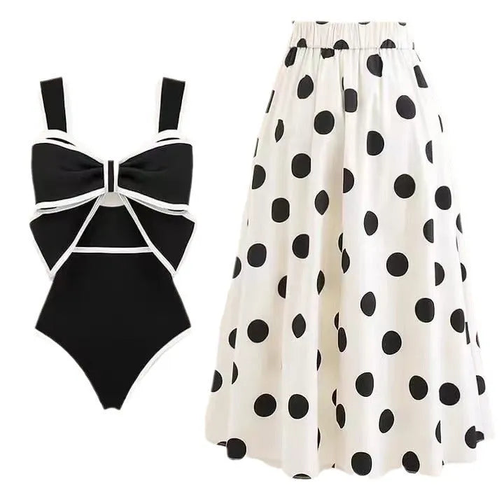 Women's black one-piece swimsuit with white attached skirt beach dress and bow trim