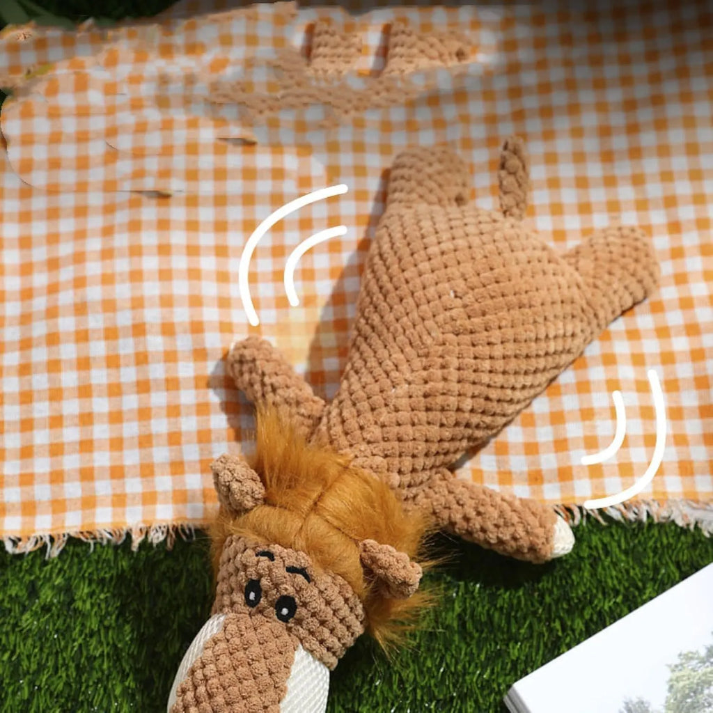 Green plush dog chew toy shaped like an animal with a corn kernel texture and a squeaker inside.