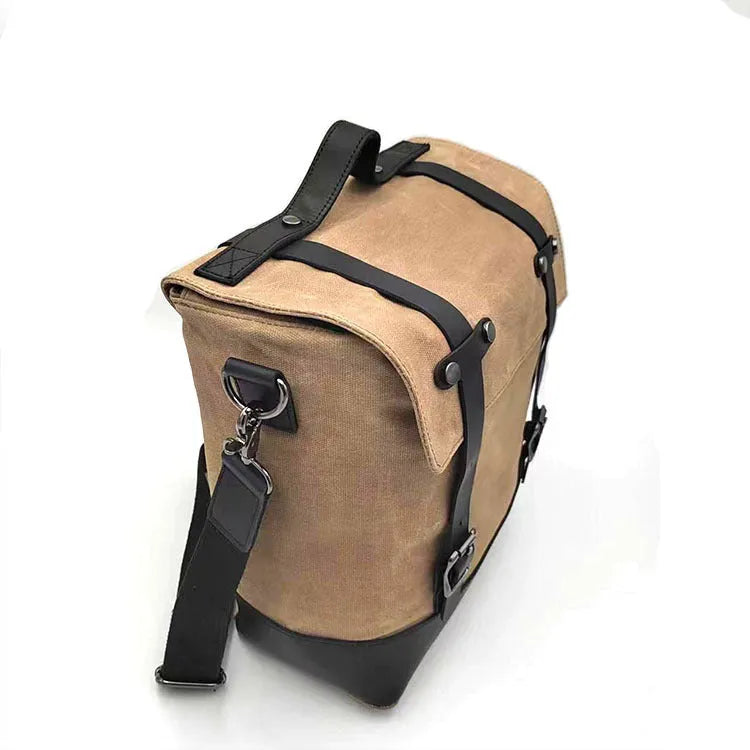 Large black waterproof canvas motorcycle side bag with cowhide top layer mounted on motorcycle