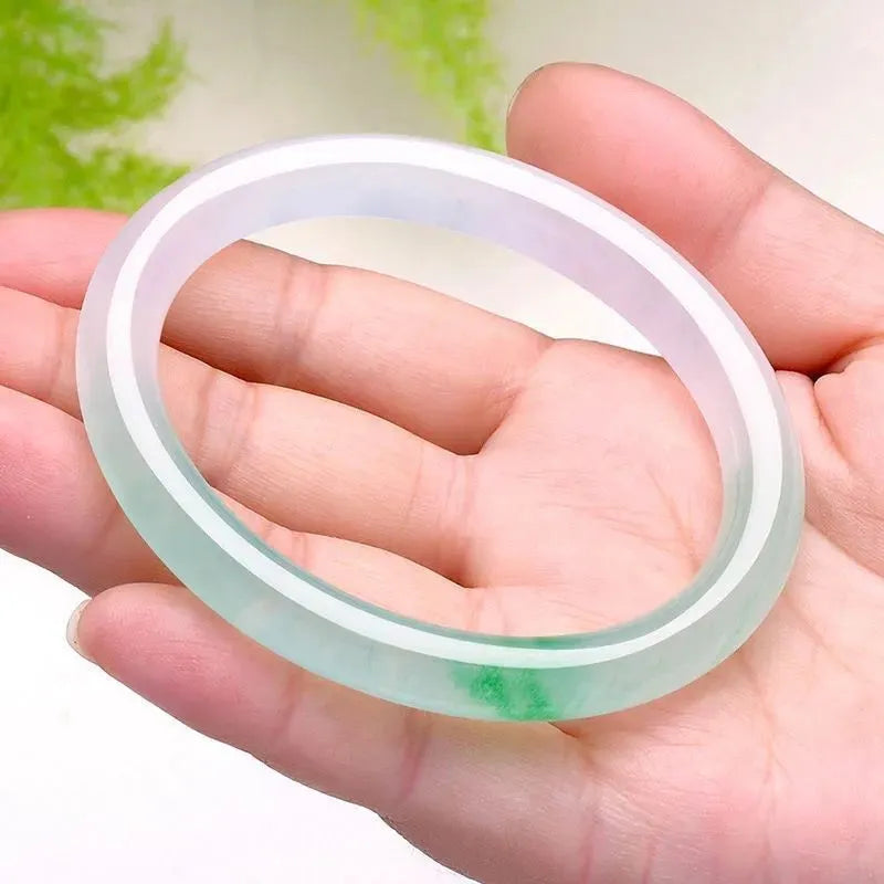 Women's jade bracelet with floating flower design in ice-like emerald appearance