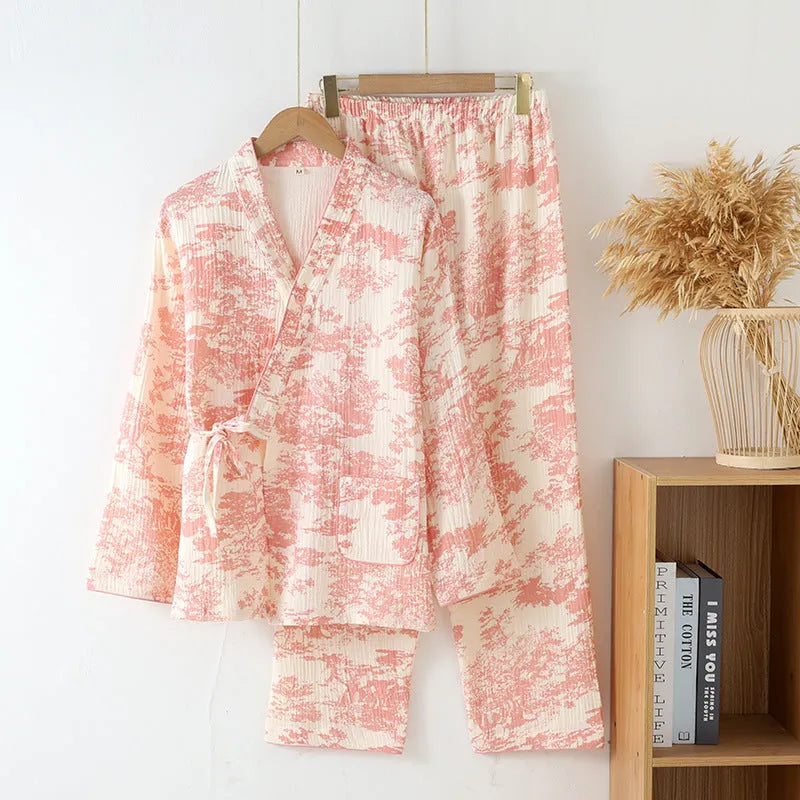Women's pink pure cotton gauze long sleeve pyjama set with lace-up trousers laid flat.