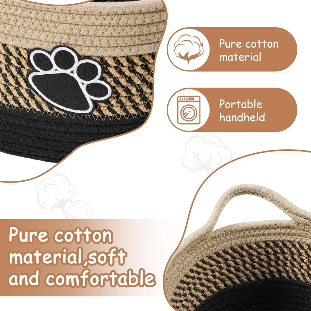 Light beige handmade woven cotton rope storage basket with wooden base and handle on a table.