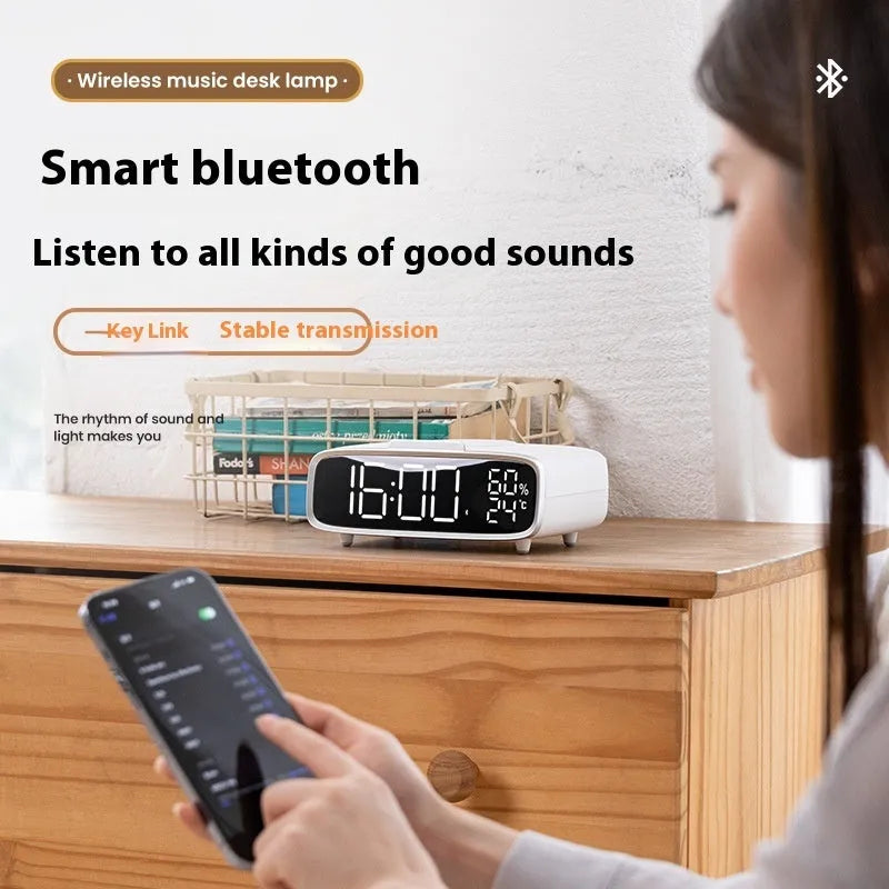 White ABS acrylic Bluetooth speaker wireless charging night lamp on a surface.