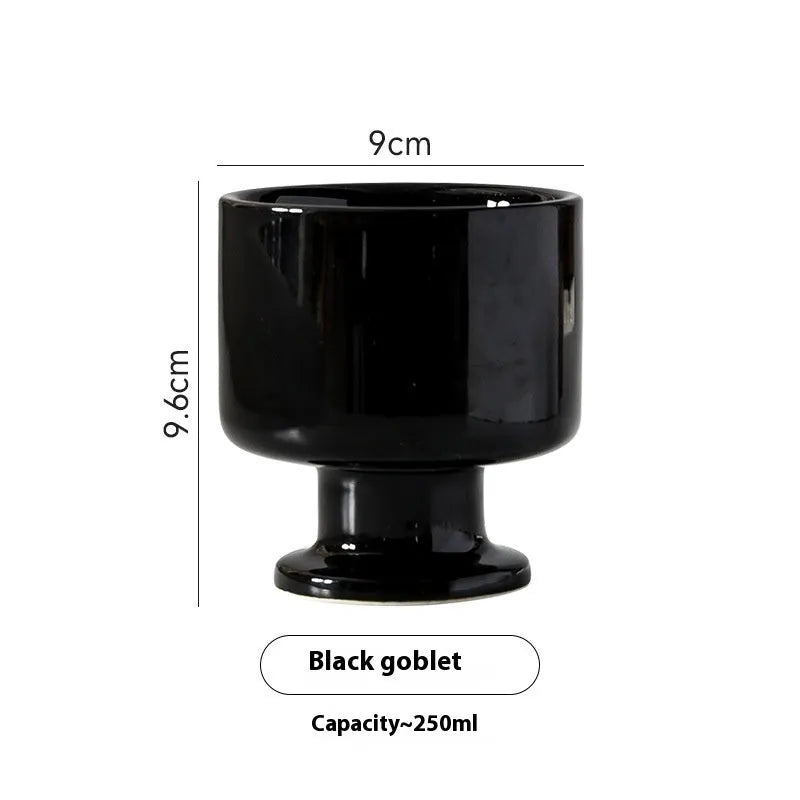 Hand-pinched irregular shaped ceramic mug in a solid colour on a table.