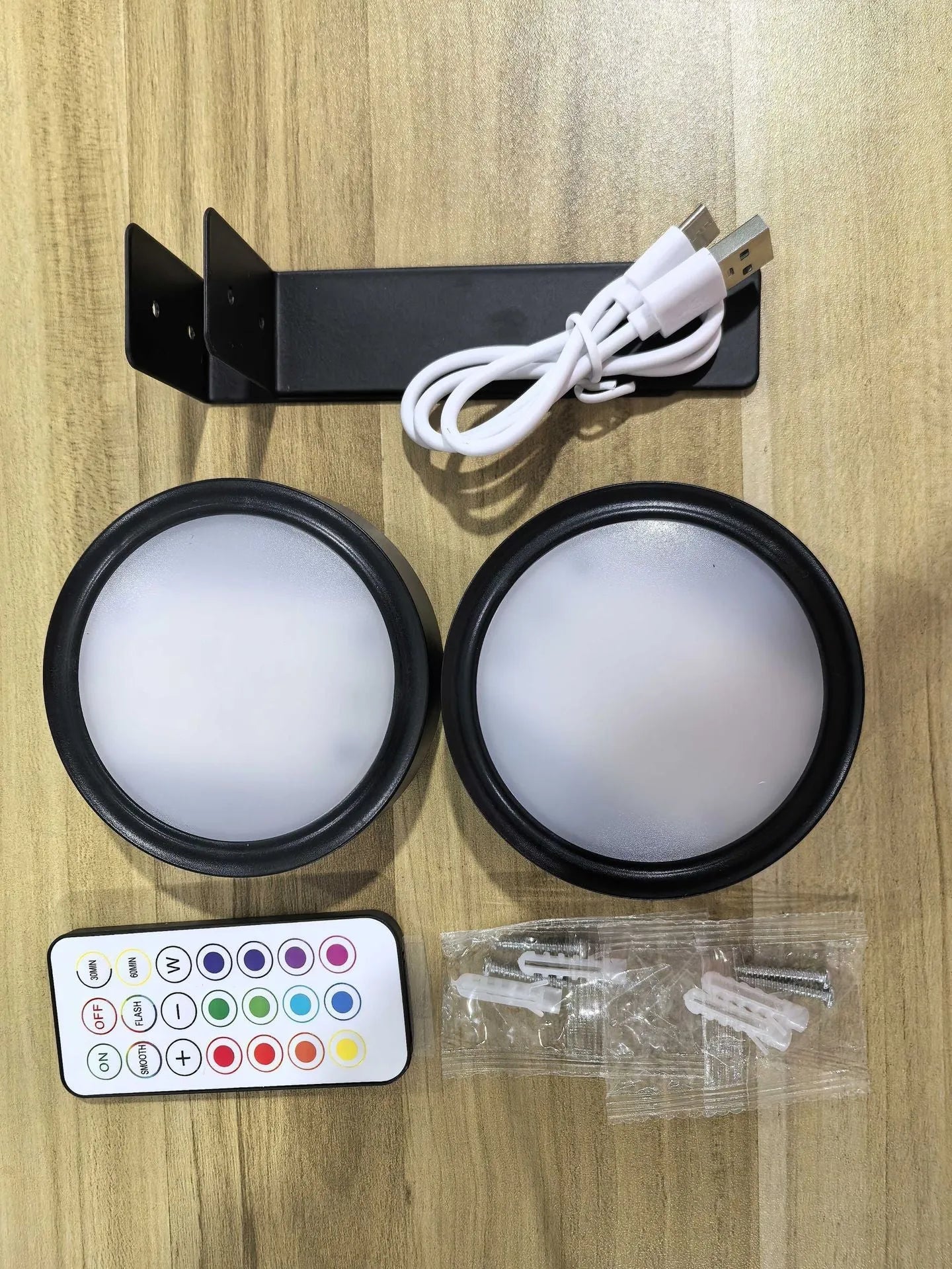 Wireless rechargeable LED painting lamp with magnetic belt attached to a metal frame, remote control nearby.