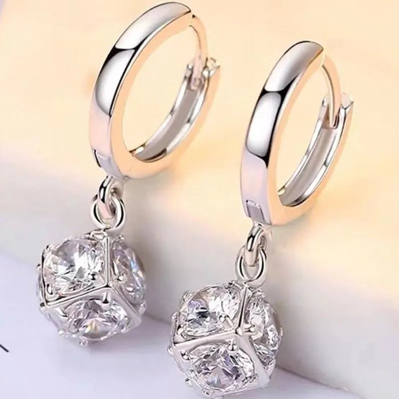 Women's geometric copper earrings with zircon and rose design elements in various colours