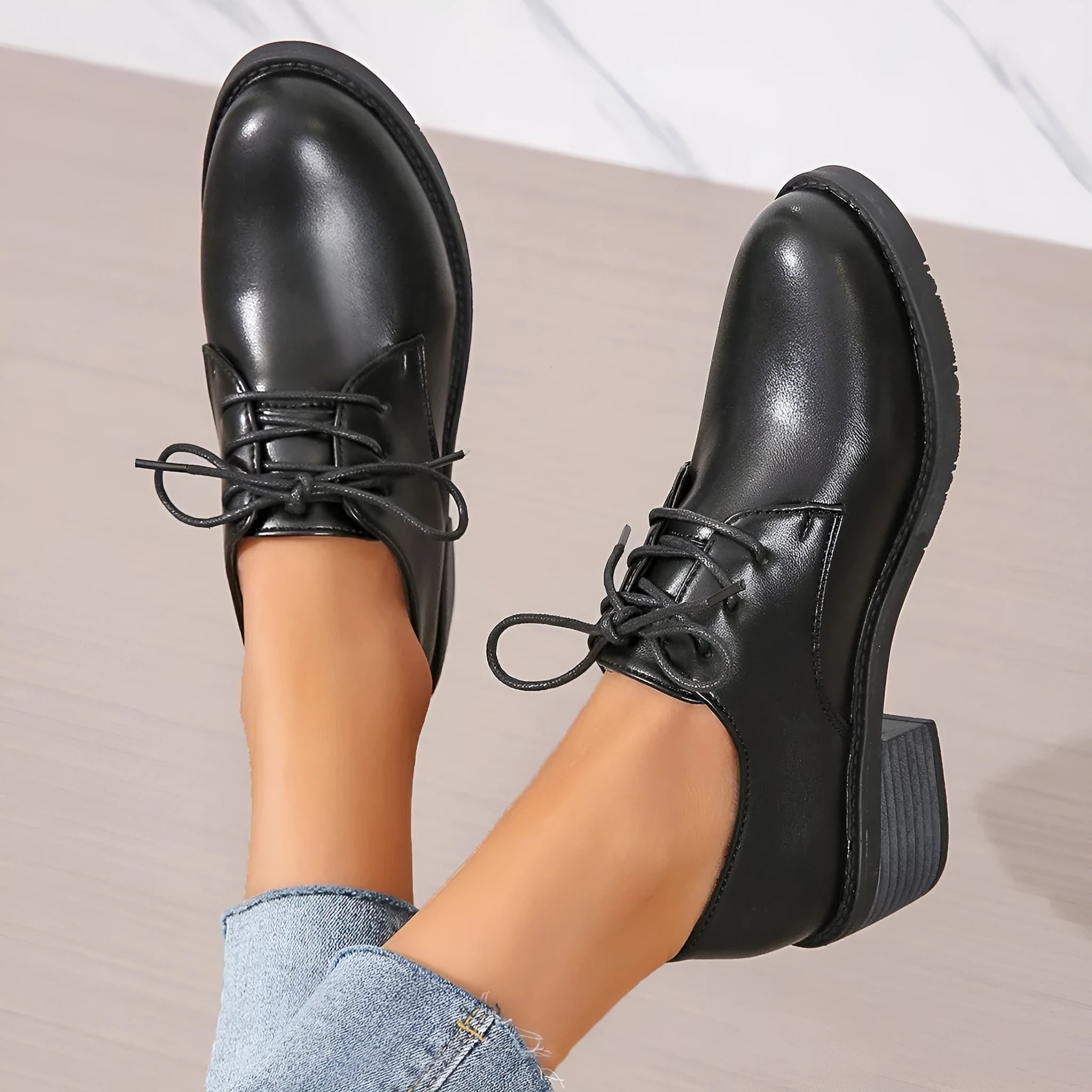 Black women's low-top slip-on work shoes with a chunky mid-heel and rounded toe.