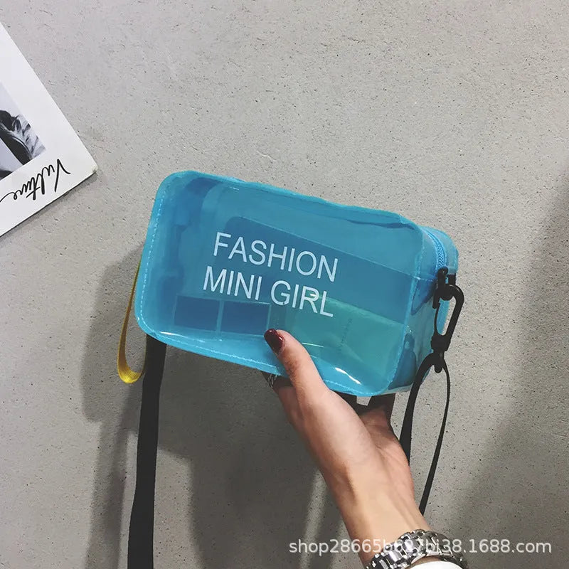 Transparent square women's shoulder bag in jelly material with a diagonal cross strap, showing internal mobile phone pocket.