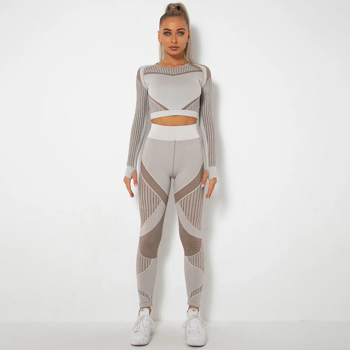 Women's long-sleeved seamless knitted yoga suit in a neutral colour, showing the stretch fabric and close fit.