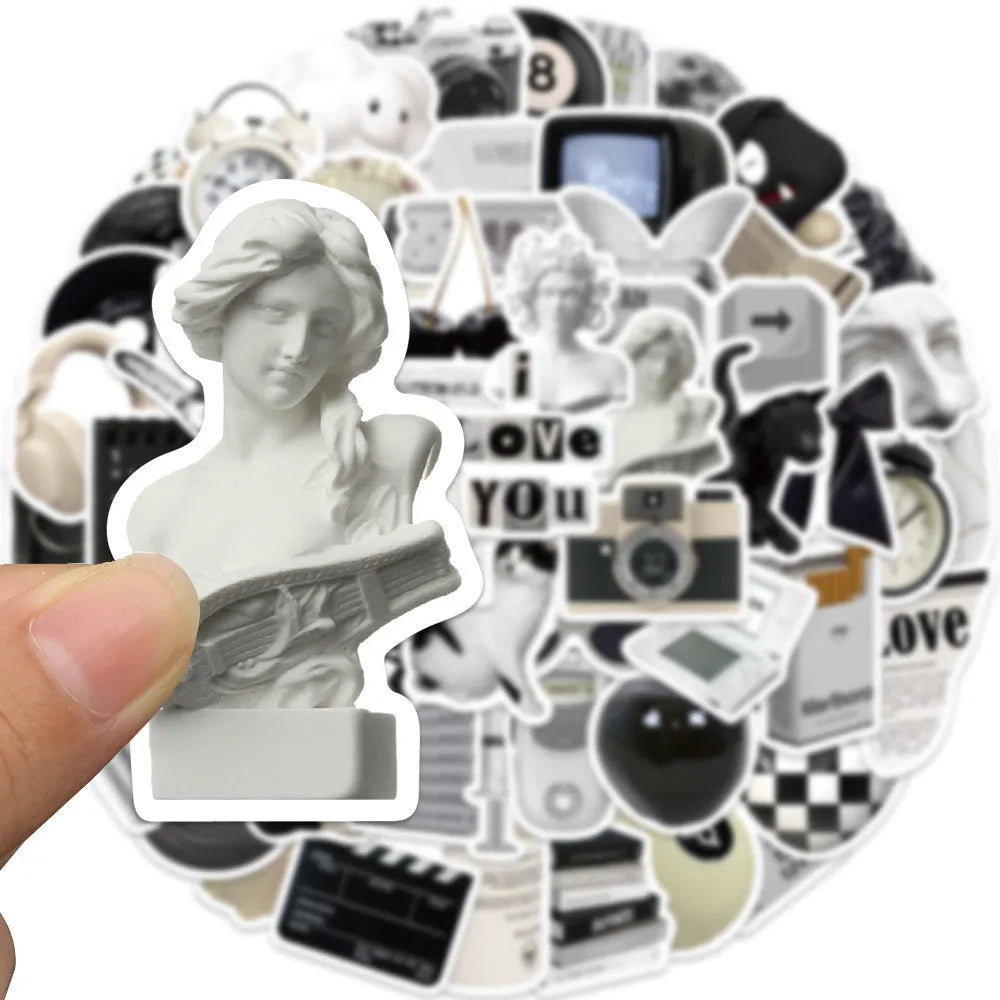 Assortment of 61 black and white waterproof PVC stickers for laptops, phones, and travel gear.