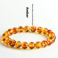 Natural yellow piebald amber bracelet with geometric beads on wrist