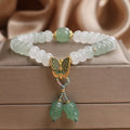 Green crystal Tian Shan Cui abacus bead bracelet with butterfly tassel, pearls and rhinestones.