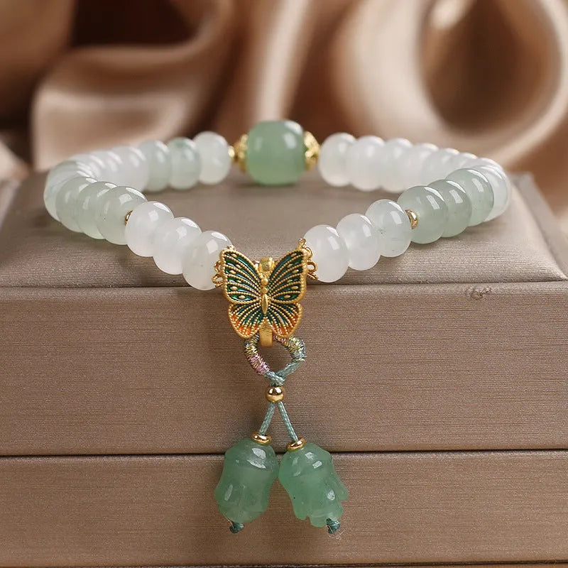 Green crystal Tian Shan Cui abacus bead bracelet with butterfly tassel, pearls and rhinestones.