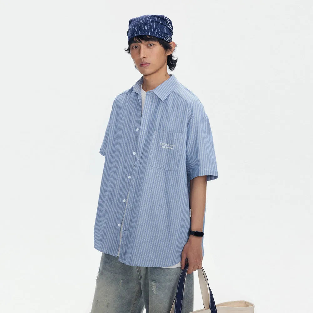 Blue striped short-sleeved shirt overalls with loose fit design on mannequin