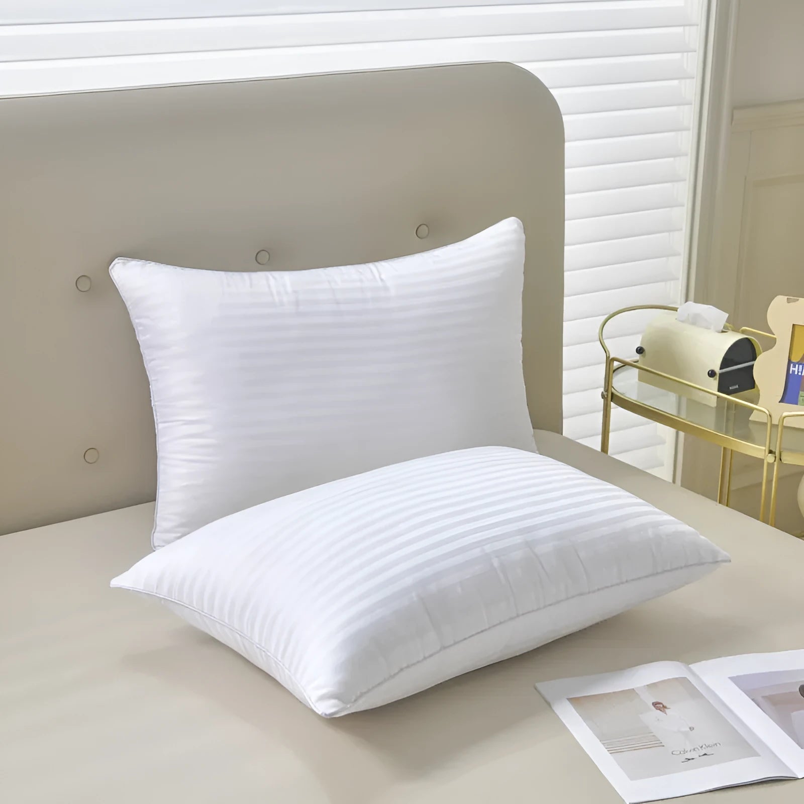 White cotton feather pillow with satin stripe detail, shown in low, medium, and high loft options.