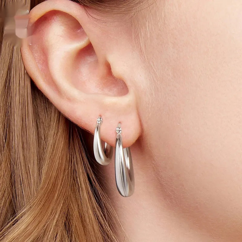 Copper geometric ring ear clip earrings in large, medium, and small sizes on a plain background.